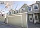 A charming exterior view showcasing the townhome's garage, front door, and a well-maintained facade at 11205 Holly St, Thornton, CO 80233
