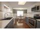 Bright kitchen with stainless appliances, hardwood floors, and an adjacent dining area at 11205 Holly St, Thornton, CO 80233