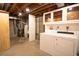 Functional laundry area with washer, dryer, storage cabinets and utility sink at 11205 Holly St, Thornton, CO 80233
