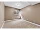 Basement room showcasing neutral walls, cozy carpeting, and a window providing natural light at 14204 E Radcliff Cir, Aurora, CO 80015