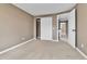 Bedroom showcasing a closet, neutral color scheme, and an open doorway to another room at 14204 E Radcliff Cir, Aurora, CO 80015
