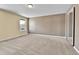 Large bedroom features neutral carpet, double closet, and a bright window at 14204 E Radcliff Cir, Aurora, CO 80015