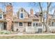 Charming townhome with a brick chimney and a well-maintained front yard and white picket fence at 14204 E Radcliff Cir, Aurora, CO 80015