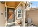 Inviting front porch with seating, address display, and a decorative front door at 14204 E Radcliff Cir, Aurora, CO 80015