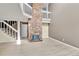 Bright living room with hardwood floors, brick fireplace, and open staircase at 14204 E Radcliff Cir, Aurora, CO 80015