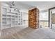 Spacious living area with a painted brick accent and wall-to-wall carpet at 14204 E Radcliff Cir, Aurora, CO 80015