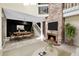 Staged living and dining area featuring a brick fireplace and modern furnishings at 14204 E Radcliff Cir, Aurora, CO 80015