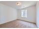 Simple bedroom with neutral carpet, white walls, and a single window at 4652 Windmill Dr, Brighton, CO 80601