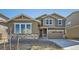 Beautiful two-story home with stone accents, neutral siding, and a two-car garage at 4652 Windmill Dr, Brighton, CO 80601