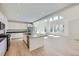Bright kitchen with a center island, stainless steel appliances, and an open floor plan at 4652 Windmill Dr, Brighton, CO 80601