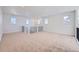 Bright and airy loft space with neutral carpeting and lots of natural light from multiple windows at 4652 Windmill Dr, Brighton, CO 80601