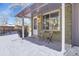 Cozy front porch with two chairs and winter scene at 1682 S Kline Way, Lakewood, CO 80232