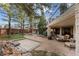 Beautiful backyard with patio, hot tub, lush landscaping, and mature trees, creating a private retreat at 65 Royal Ann Dr, Englewood, CO 80111