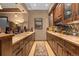 The bar area features granite countertops, wooden cabinetry, wine storage, and a mirrored backsplash at 65 Royal Ann Dr, Englewood, CO 80111