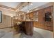 Home bar offers custom wood cabinets, bar seating, and display shelving at 65 Royal Ann Dr, Englewood, CO 80111