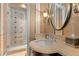 Elegant bathroom featuring a glass-enclosed shower and a stylish vanity with decorative wall accents at 65 Royal Ann Dr, Englewood, CO 80111