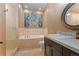 The well-lit bathroom includes a bathtub and shower combination, plus single sink vanity at 65 Royal Ann Dr, Englewood, CO 80111