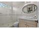 Bright bathroom featuring tiled shower, vanity with cabinets, and modern fixtures at 65 Royal Ann Dr, Englewood, CO 80111