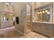 Lavish primary bathroom with dual sinks, walk-in shower, and decorative lighting at 65 Royal Ann Dr, Englewood, CO 80111