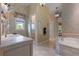 Luxurious primary bathroom featuring a separate shower and soaking tub at 65 Royal Ann Dr, Englewood, CO 80111