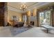 Grand primary bedroom with fireplace and decorative draperies and chandelier lighting at 65 Royal Ann Dr, Englewood, CO 80111