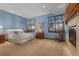 Cozy bedroom with fireplace, windows with valances, and warm, inviting decor at 65 Royal Ann Dr, Englewood, CO 80111