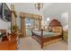 Main bedroom features decorative chandelier, large window, and custom wood accents at 65 Royal Ann Dr, Englewood, CO 80111