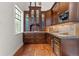 Butler's pantry featuring custom cabinetry, granite countertops, wine cooler, and stainless steel appliances at 65 Royal Ann Dr, Englewood, CO 80111