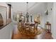 Formal dining room boasts hardwood floors, elegant chandelier, and French doors leading to outdoor patio at 65 Royal Ann Dr, Englewood, CO 80111