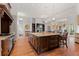 Kitchen island with a sink overlooking the fireplace at 65 Royal Ann Dr, Englewood, CO 80111