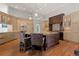 Spacious kitchen boasts a center island, wood floors, and custom cabinetry at 65 Royal Ann Dr, Englewood, CO 80111