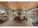 Spacious living room features a stone fireplace and floor-to-ceiling windows with backyard views at 65 Royal Ann Dr, Englewood, CO 80111