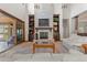 Spacious living room showcasing a stone fireplace, built-in shelving, and sliding doors to the backyard at 65 Royal Ann Dr, Englewood, CO 80111