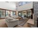 Bright and airy living room with high ceilings, stone fireplace, and expansive windows offering scenic views at 65 Royal Ann Dr, Englewood, CO 80111