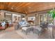 Bright living room boasts a cozy seating area and backyard view with multiple windows and access to other rooms at 65 Royal Ann Dr, Englewood, CO 80111