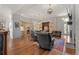Large open living area with a kitchen island, fireplace, and hardwood floors at 65 Royal Ann Dr, Englewood, CO 80111