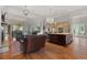 Bright open living area with wood floors, a kitchen island, and fireplace at 65 Royal Ann Dr, Englewood, CO 80111