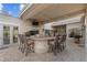 Inviting outdoor bar and patio area with seating and built-in grill, perfect for entertaining at 65 Royal Ann Dr, Englewood, CO 80111