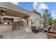 Spacious backyard patio with a built-in bar, fire pit, and ample seating for relaxing or entertaining at 65 Royal Ann Dr, Englewood, CO 80111