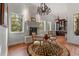 Sitting area with stone fireplace, hardwood floors, and large windows providing plenty of natural light at 65 Royal Ann Dr, Englewood, CO 80111