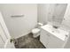 Bathroom with modern vanity, mirror, toilet, and ceramic tile flooring at 2875 S Espana Ct, Aurora, CO 80013