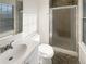Bright bathroom featuring a glass-enclosed shower and modern fixtures at 2875 S Espana Ct, Aurora, CO 80013