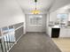 Bright dining area with grey carpet and a chandelier, view into kitchen at 2875 S Espana Ct, Aurora, CO 80013