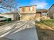 Two-story home with a two-car garage, a well-maintained lawn, and mature trees at 2875 S Espana Ct, Aurora, CO 80013