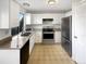 Modern kitchen with stainless steel appliances, white cabinetry and a large window at 2875 S Espana Ct, Aurora, CO 80013
