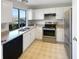 Bright kitchen featuring stainless steel appliances, white cabinets, and a large window at 2875 S Espana Ct, Aurora, CO 80013