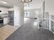 Bright living room flows into the kitchen, featuring new carpet and fresh paint at 2875 S Espana Ct, Aurora, CO 80013