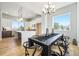Bright dining room with a modern chandelier, stylish table setting, and a view into the kitchen at 888 S Valentia St # 104, Denver, CO 80247
