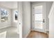 Bright entryway features wood floors, a frosted glass front door, and leads to a carpeted living space at 888 S Valentia St # 104, Denver, CO 80247