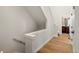 Bright hallway leading to bathroom and staircase with wood flooring at 888 S Valentia St # 104, Denver, CO 80247